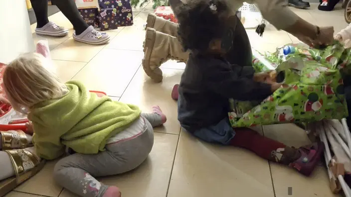Kinder packen Geschenke aus